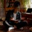 Woman journaling mental health triggers at home
