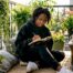 Woman writing mental health story at home