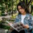 Person reviewing Freudian fashion catalog at café table
