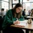 Woman writing coping skills checklist at kitchen table