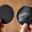 Hands holding matte and glossy stickers side by side