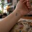 Semicolon tattoo on wrist close-up