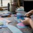 Hands creating a mental health awareness poster