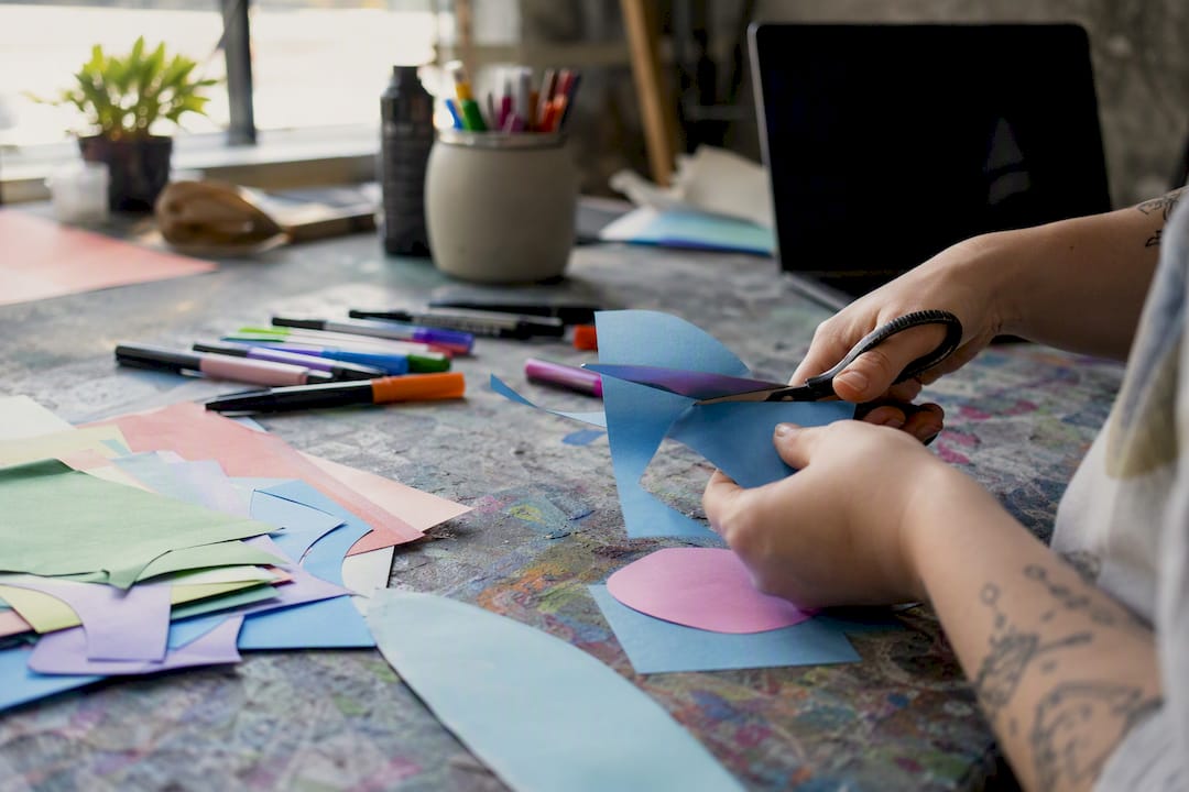 Hands creating a mental health awareness poster