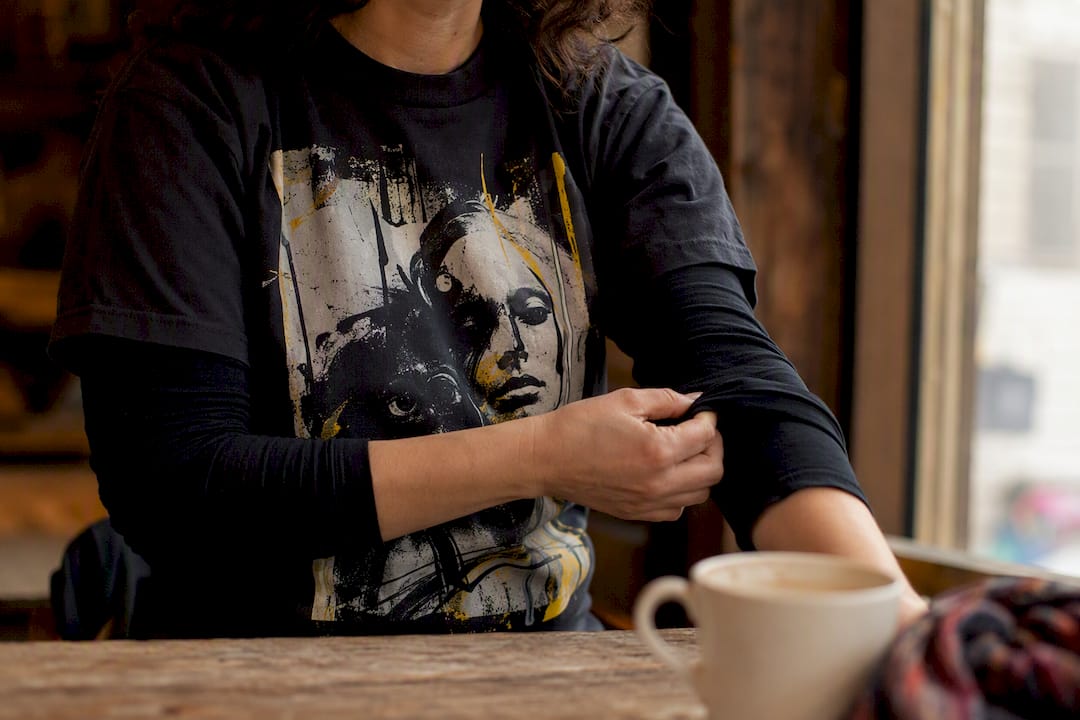 Close-up of person adjusting awareness t-shirt sleeve