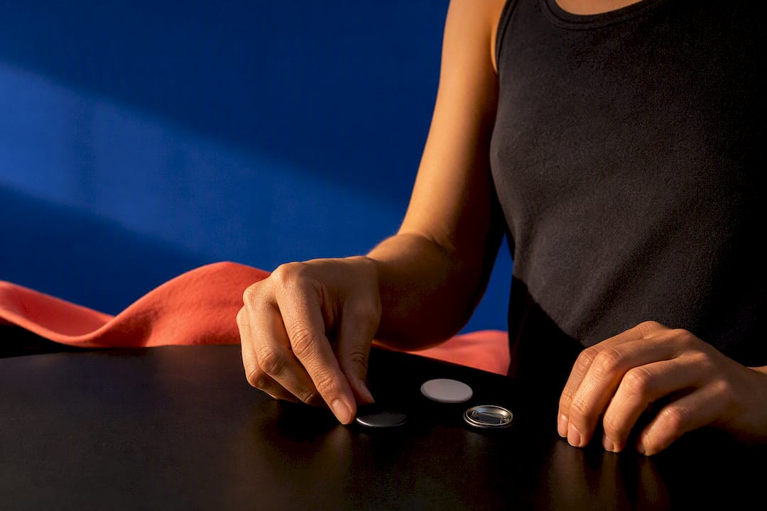 Cropped tank top beside campaign buttons