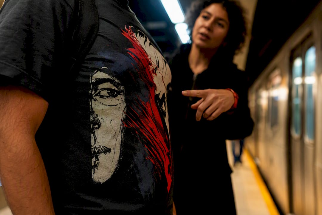 Commuters discussing partial graphic shirt