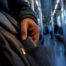 Hand discreetly accessing medication on train