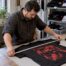 Technician measuring washed cotton T-shirt