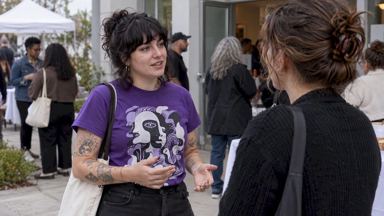 Attendees discussing an advocacy outfit at fundraiser