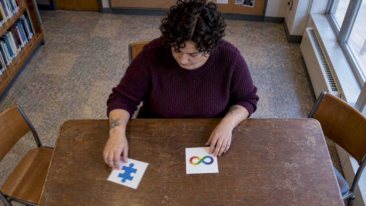 Advocate compares puzzle-piece and infinity symbols