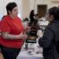 Advocate talking with an attendee at a booth