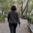 Woman walking through a leafy city park